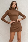 This two-piece set features a flattering ribbed design, long sleeve mock-neck top, and a cropped, elastic waistband skirt with a front slit. The mini length adds a playful touch to this trendy ensemble.