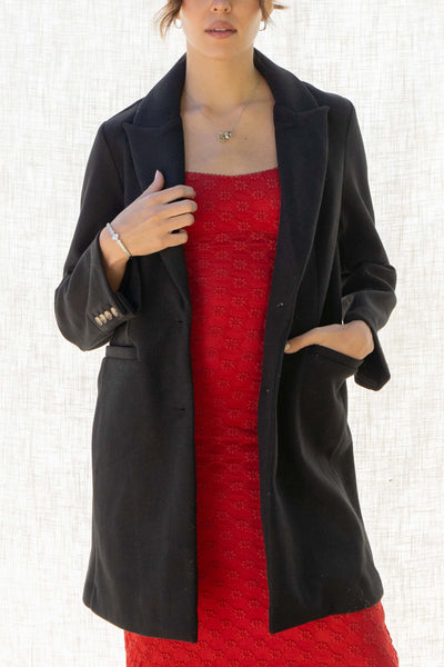 Beverly Two Button Long Coat. The collared neckline and long sleeves keep you warm, while the two button closure and front pockets add style and functionality.