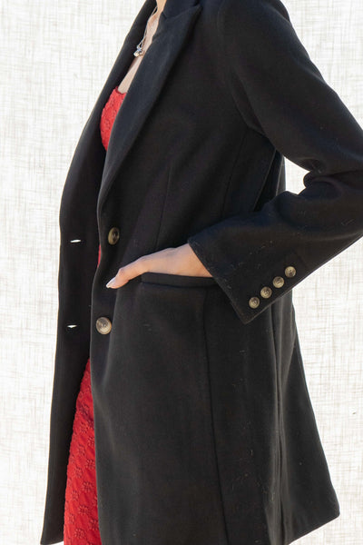 Beverly Two Button Long Coat. The collared neckline and long sleeves keep you warm, while the two button closure and front pockets add style and functionality.