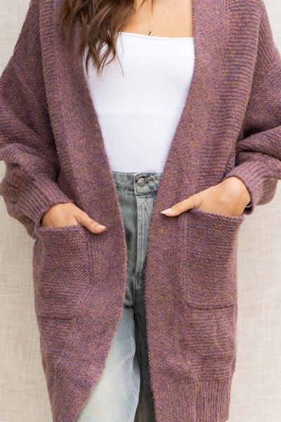 With its oversized fit, it provides a relaxed look while the front pockets add convenience. Made from a soft touch material and featuring bubble sleeves, this cardigan is a must-have for any fashion-forward individual!