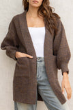 With its oversized fit, it provides a relaxed look while the front pockets add convenience. Made from a soft touch material and featuring bubble sleeves, this cardigan is a must-have for any fashion-forward individual!