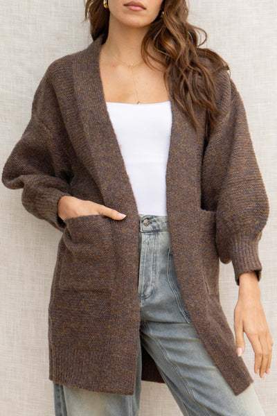 With its oversized fit, it provides a relaxed look while the front pockets add convenience. Made from a soft touch material and featuring bubble sleeves, this cardigan is a must-have for any fashion-forward individual!